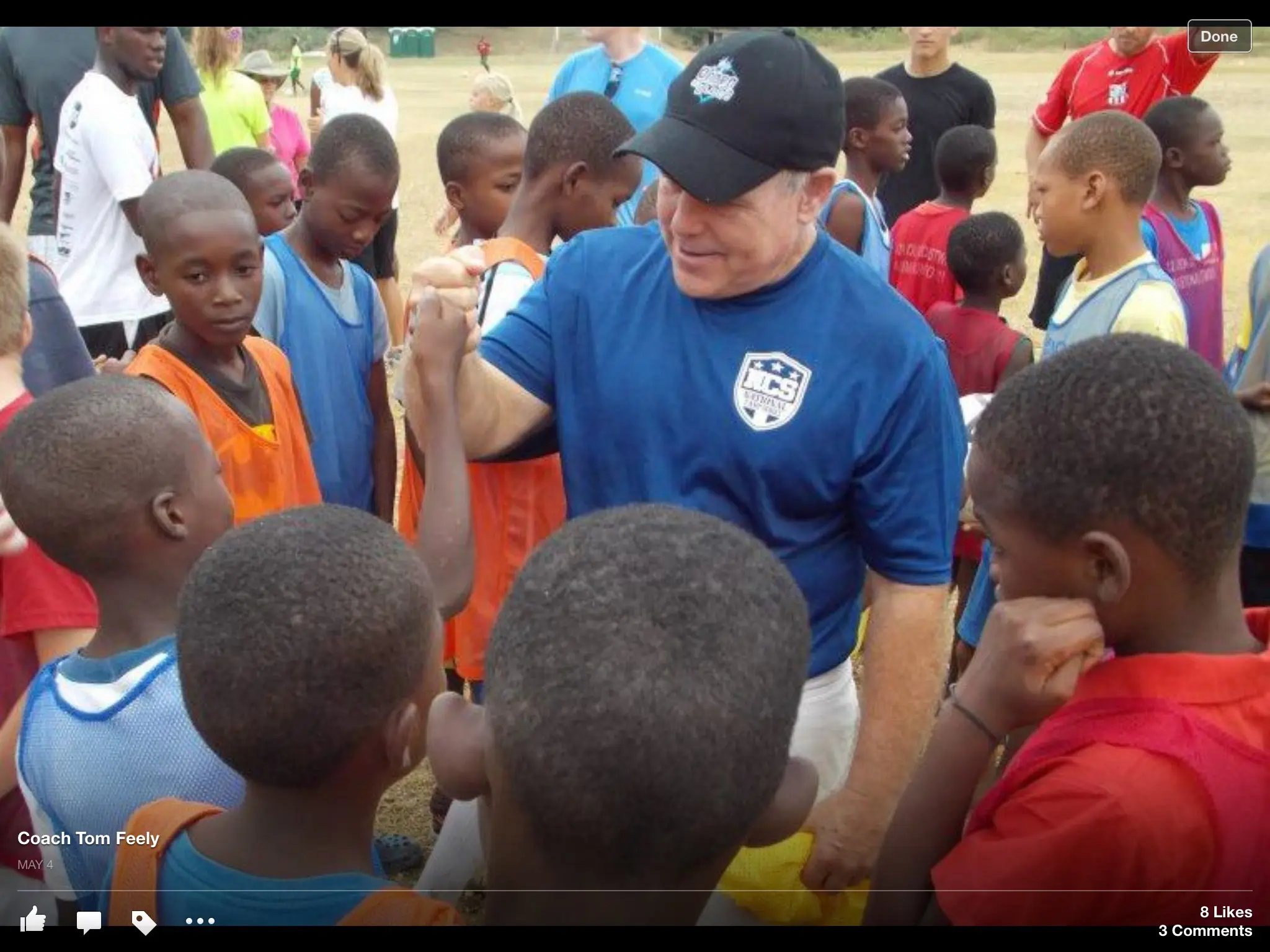 Coach motivating youth soccer players at field
